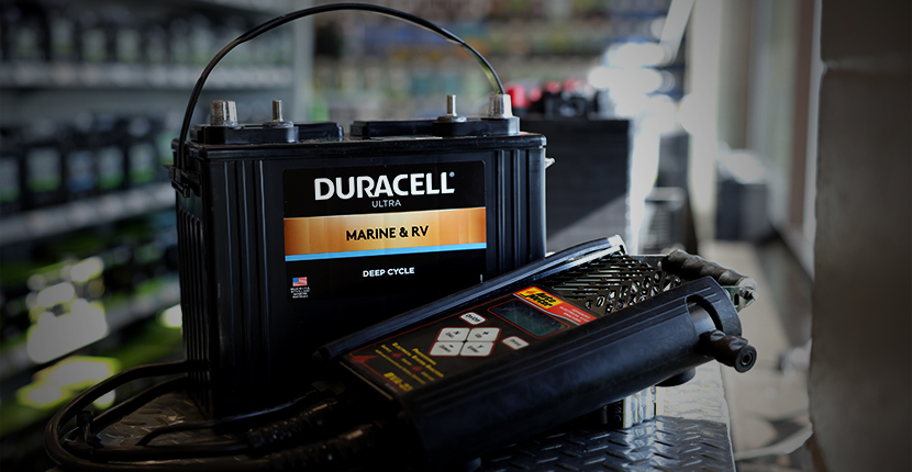 Marine deep cycle battery with a battery tester on a counter