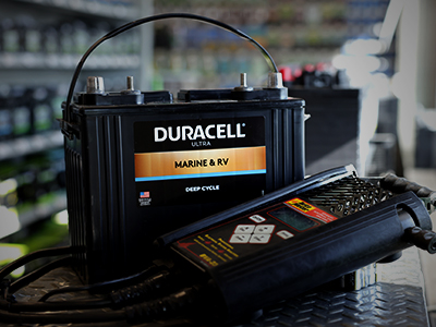 Marine deep cycle battery with a battery tester on a counter