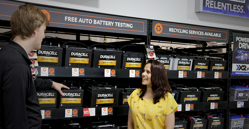 Employee talking to a customer about auto batteries