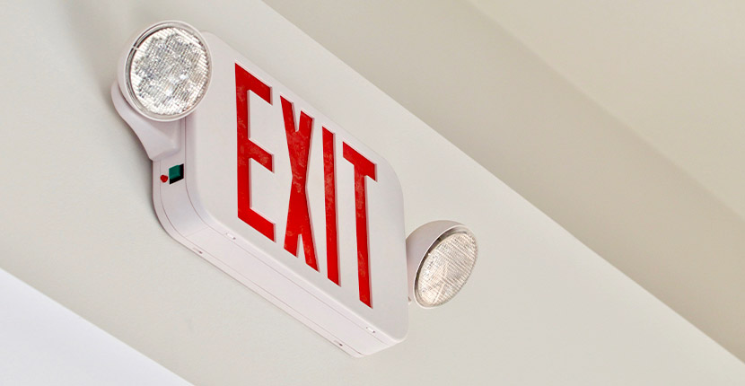 Emergency exit sign on business wall