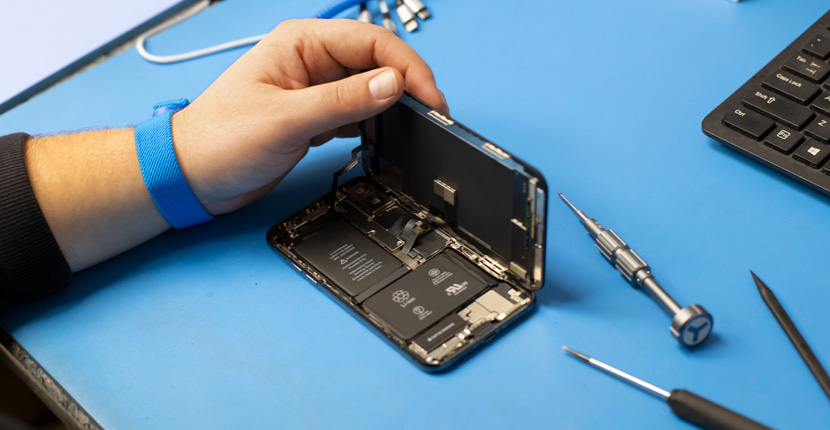 Someone opening a cell phone to replace the battery