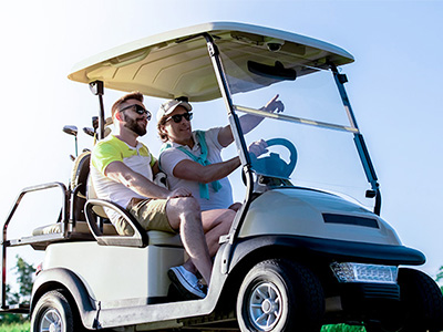 Two guys in a golf cart