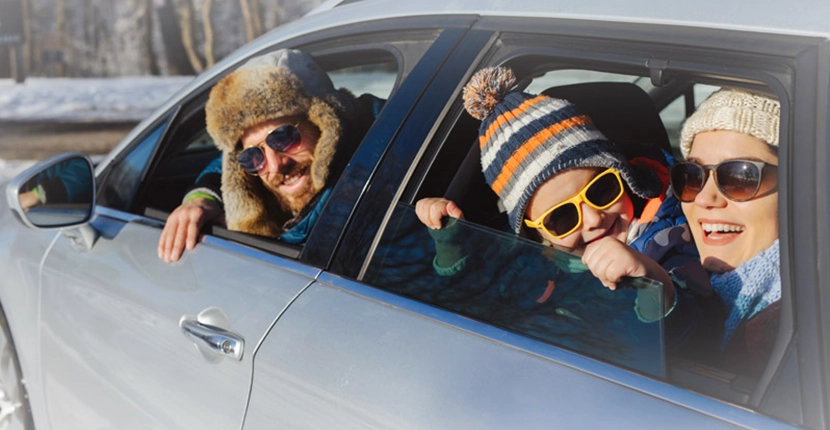 three people in a car looking out the windows