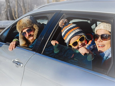 three people in a car looking out the windows