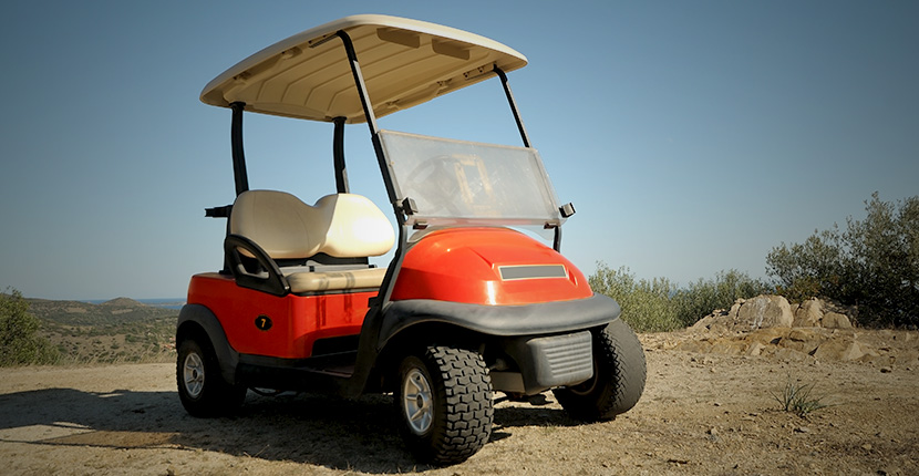 Golf cart on a dirt patch