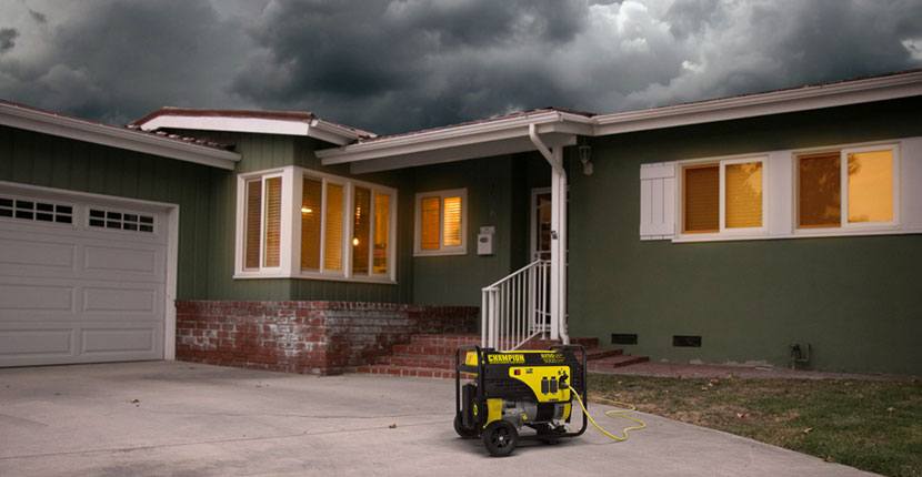Generator sitting in the driveway of a house with stormy skies