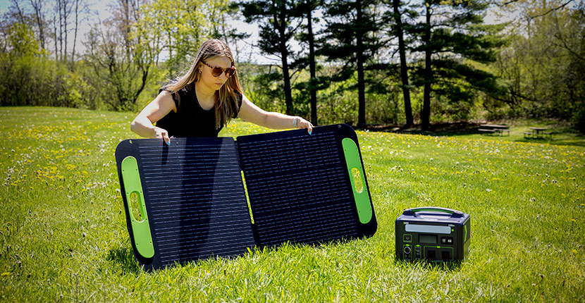 Person setting up an X2Power solar panel to charge an X2Power power station