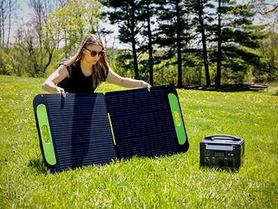 Person setting up an X2Power solar panel to charge an X2Power power station