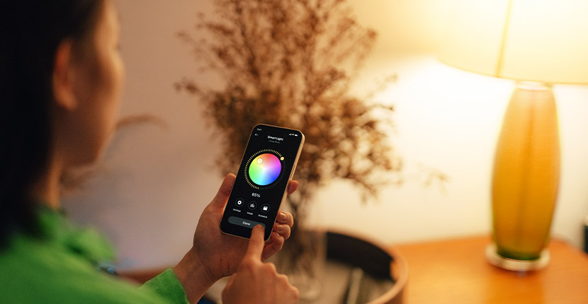 Person controlling the color of a smart bulb with their phone