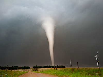A tornado over a field and trees