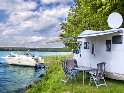 RV near the waters edge with a boat docked