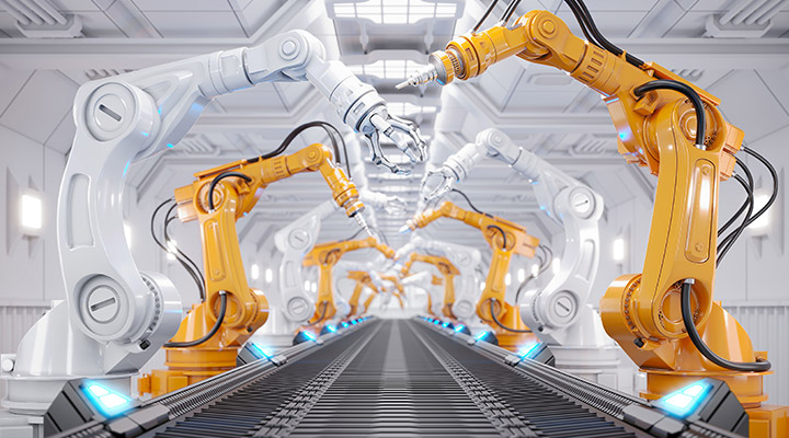 White and Orange robotic arms along a conveyer belt