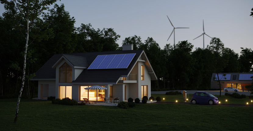 House with solar panels and wind turbines in the background