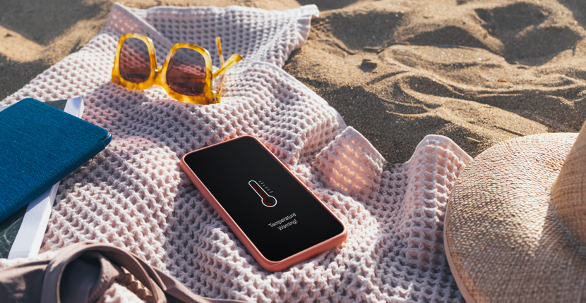 Phone laying out on a towel on the beach