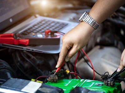 Using a multimeter to check on a battery