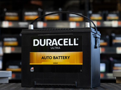 car battery sitting on a counter in front of an auto battery wall