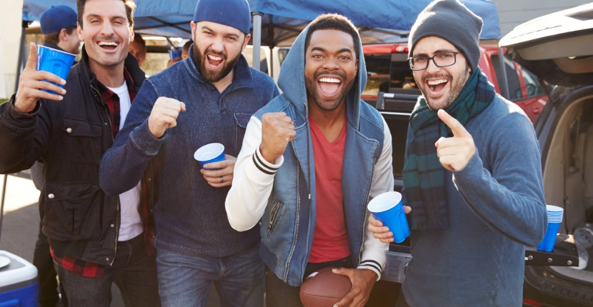 Group of people in sweaters and jackets tailgating