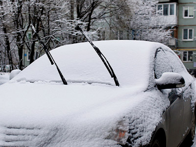 car in the snow with wiper blades up