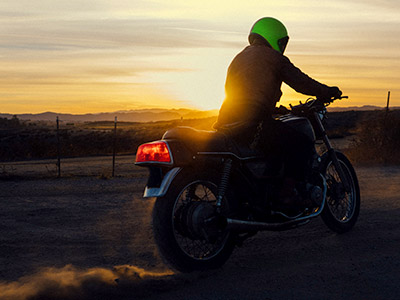 riding a motorcycle at dusk