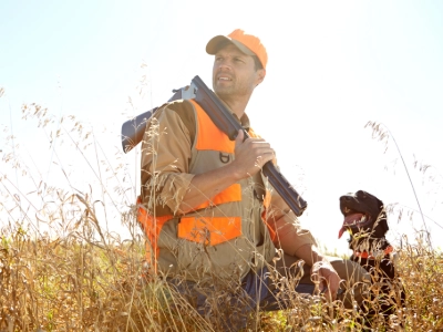 Man with his hunting dog in a field