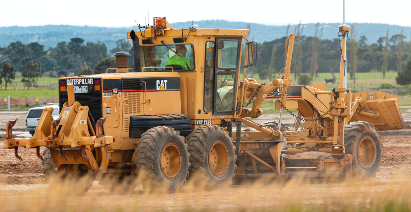 Caterpillar tractor moving dirt at a work site