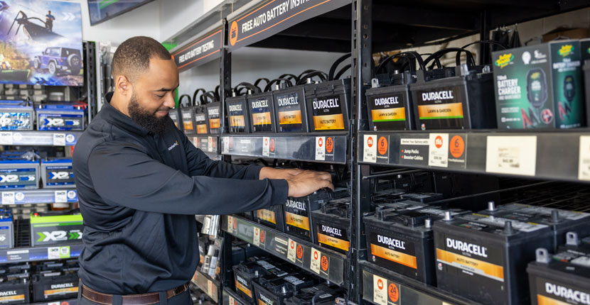 Employee checking over batteries on the rack
