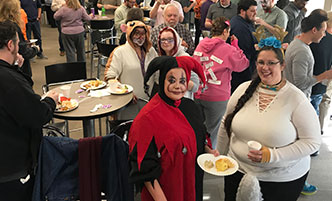 Corporate employees having a chili cook-off during Halloween