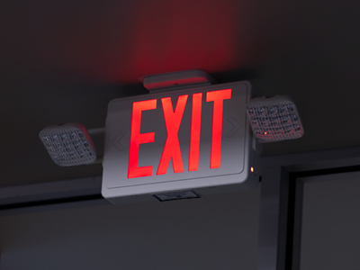 Exit sign on the ceiling in a dark hallways