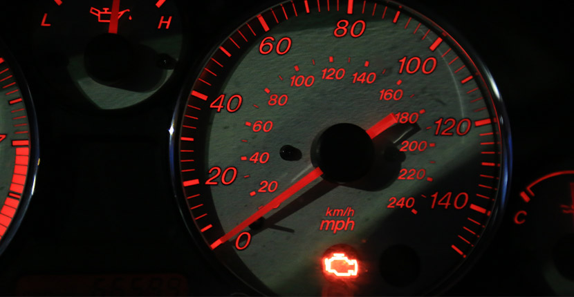 Vehicle dashboard with a check engine light on