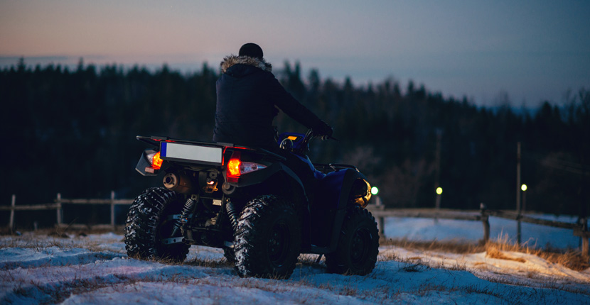 ATV driving in a snowy field