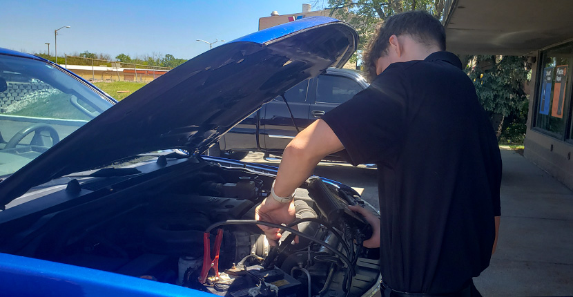 Car battery being tested by an employee