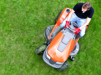 Man on Riding Mower Mowing Lawn
