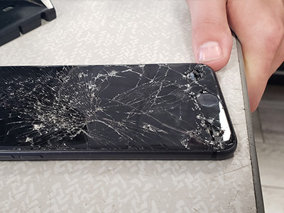 Phone with cracked screen on a table
