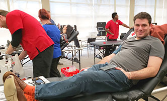 Corporate employee giving blood